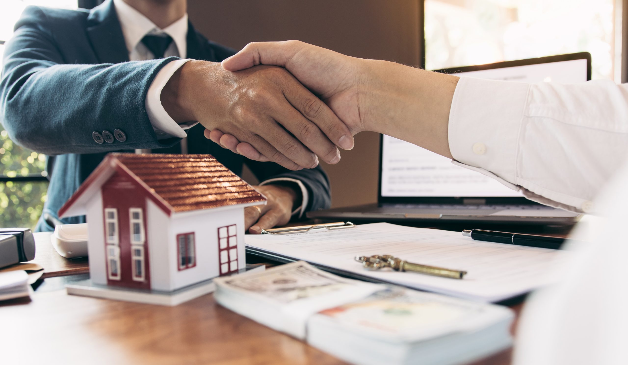 Home sales agents and buyers work on signing new homes and shaki